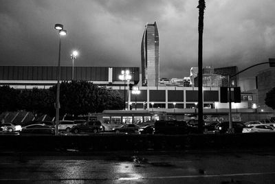 Illuminated street lights against sky at night