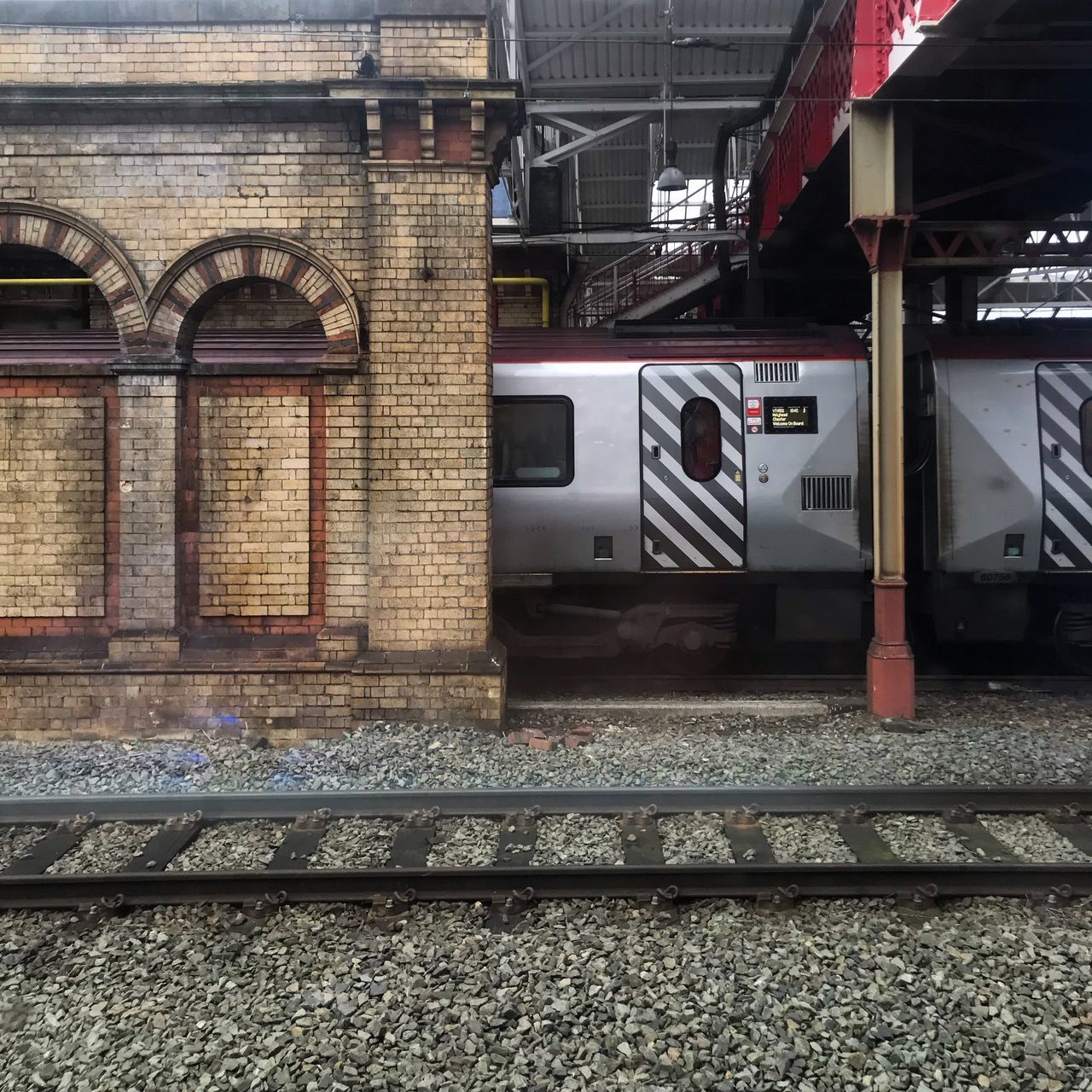 TRAIN IN RAILROAD STATION PLATFORM