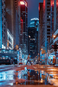 Reflection of illuminated buildings in city at night