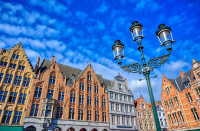 Low angle view of buildings against cloudy sky