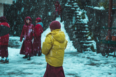 Rear view of people on snow covered trees