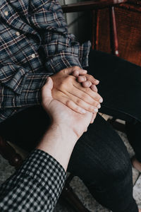 Low section of man holding hands