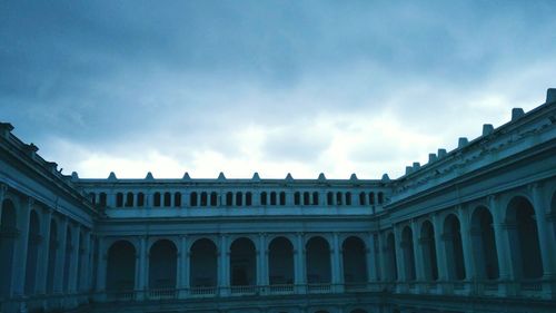 Low angle view of historical building against cloudy sky