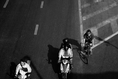 High angle view of people riding vehicles on street