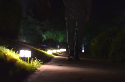 Low section of man on road at night