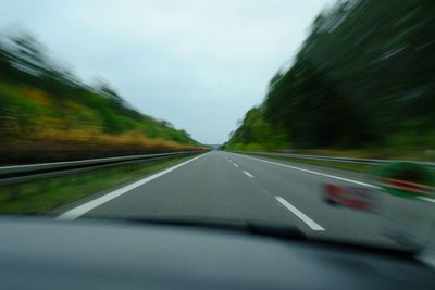 Close-up of car on road against sky