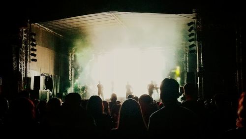 People enjoying music concert at night