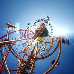 Low angle view of ferris wheel against blue sky