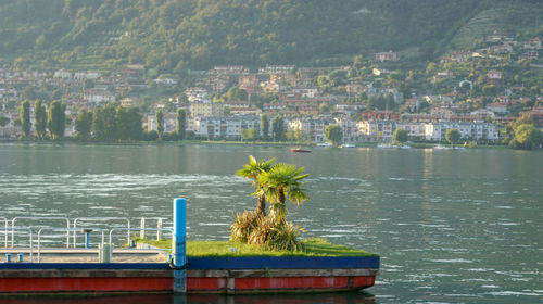 Scenic view of lake by buildings in city