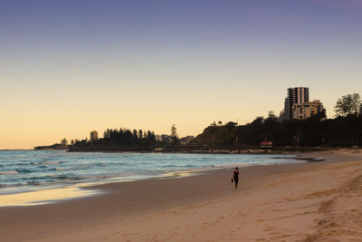 People on beach at sunset