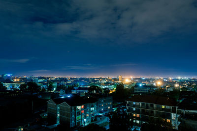 High angle view of illuminated buildings against sky at dusk