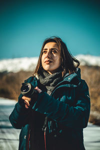 Young woman holding camera