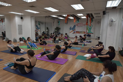 Group of people sitting on wooden floor