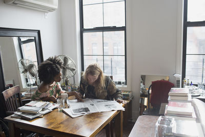 A young couple at a dining table