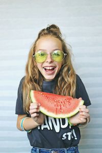 Portrait of smiling girl holding watermelon