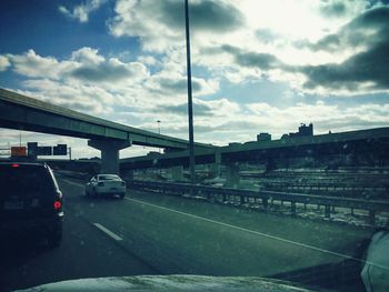 Train on road against cloudy sky