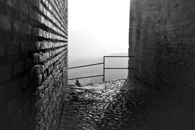 Alley amidst buildings against clear sky