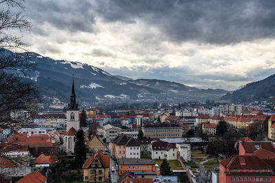 High angle view of townscape and mountains against sky