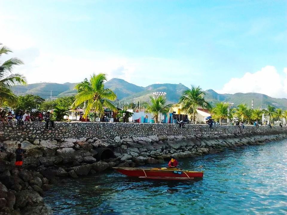 water, sky, mountain, nautical vessel, transportation, waterfront, boat, mode of transport, built structure, river, tree, cloud - sky, nature, architecture, tranquil scene, scenics, lake, moored, day