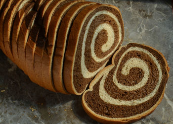 High angle view of sliced marble rye bread on table