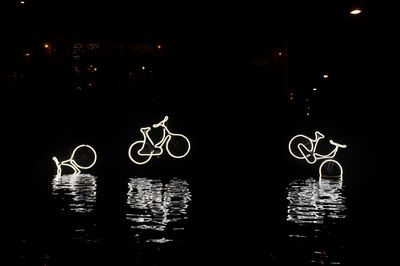 Illuminated basketball hoop at night