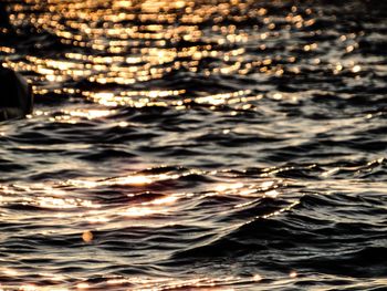 Close-up of rippled sea against sky during sunset