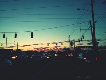 Cars on road at sunset