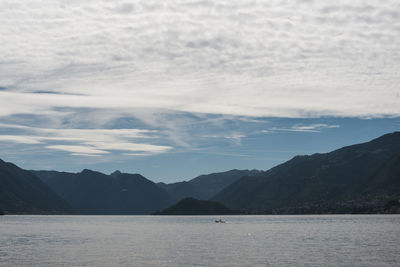 Scenic view of sea and mountains against sky