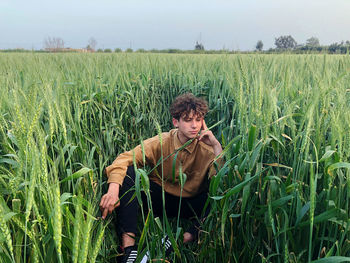 Portrait of woman standing on field