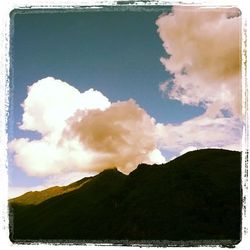 Scenic view of mountains against cloudy sky