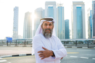 Portrait of man wearing traditional clothing standing in city