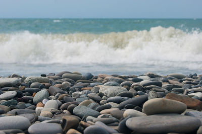 Rocks on beach against sky