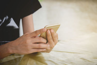 Midsection of woman using phone