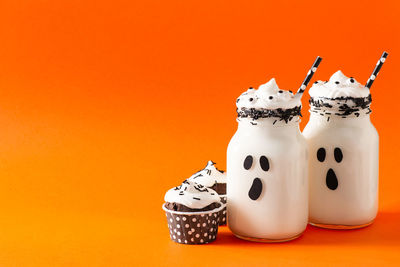 Close-up of cake against orange background