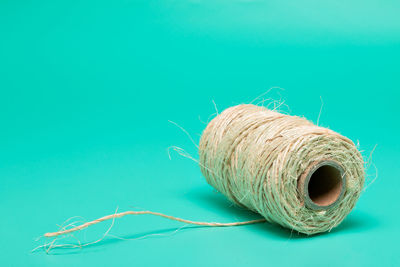 Close-up of rope over blue background