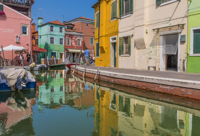 Canal by houses in city