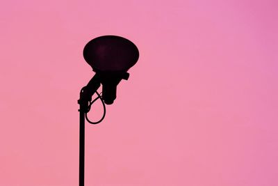 Low angle view of street light against pink sky