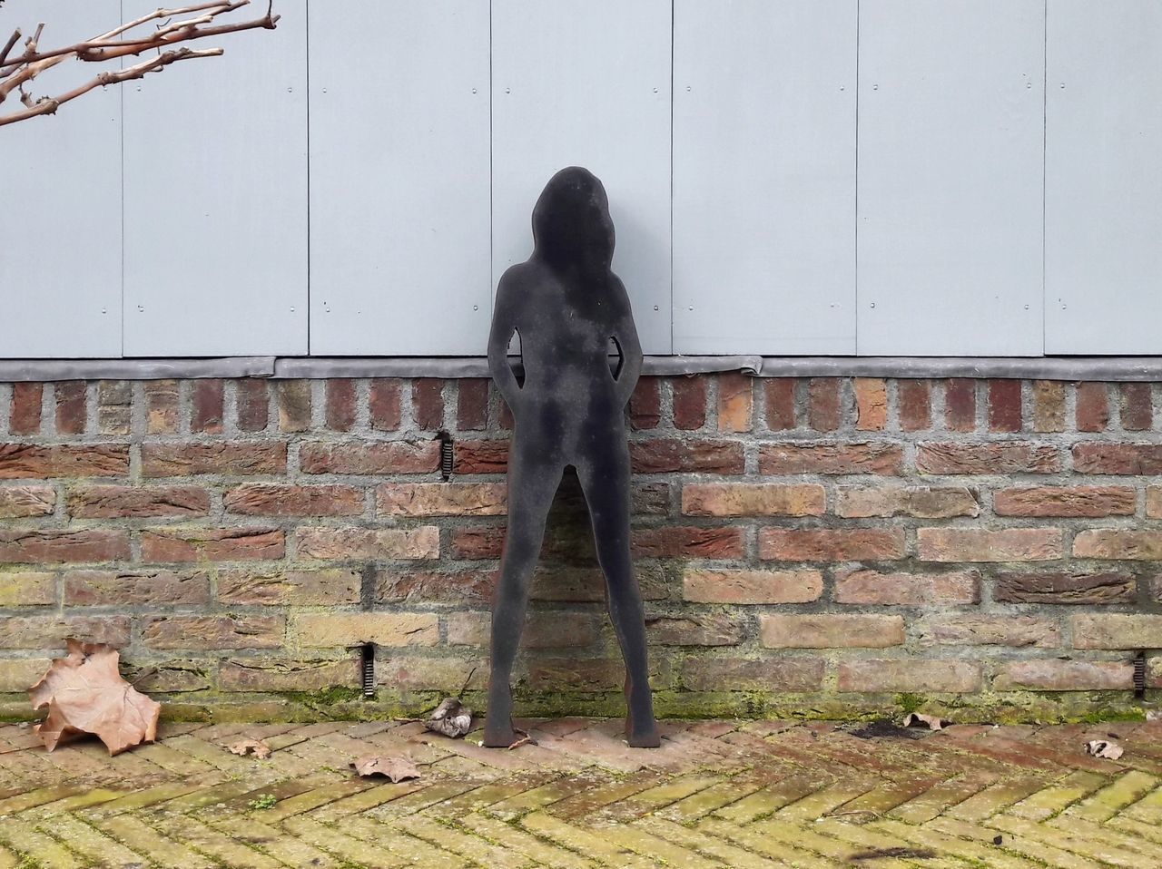 WOMAN STANDING AGAINST WALL