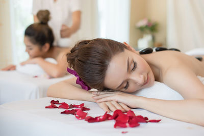 Young woman lying on massage table in spa