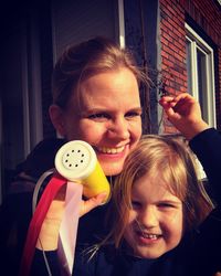 Portrait of a smiling girl holding camera