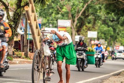 Rear view of people walking on road