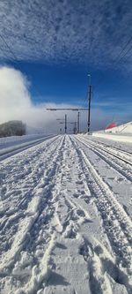 Snow covered field against sky