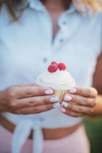 Midsection of woman holding ice cream