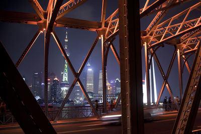 Orient pearl tower seen from bridge against sky at night