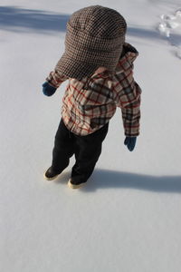 High angle view of boy standing in snow