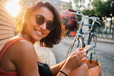 Portrait of smiling young woman in sunglasses