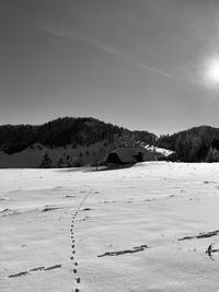 Scenic view of snowy field against sky