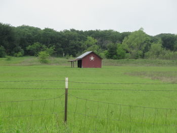 House on field against sky