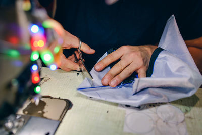 Close-up of woman making art product on table