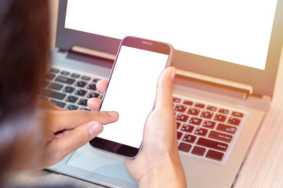 Businesswoman using technologies at table in cafe